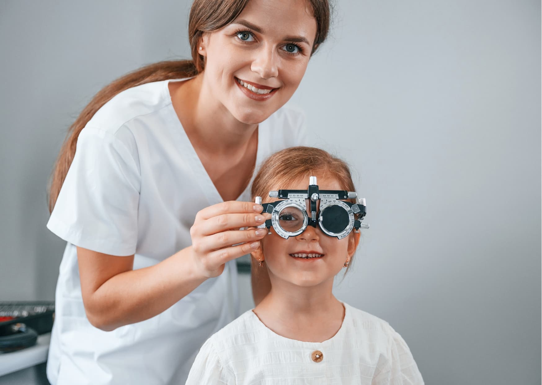 Young child receiving a pediatric eye exam with trial frames